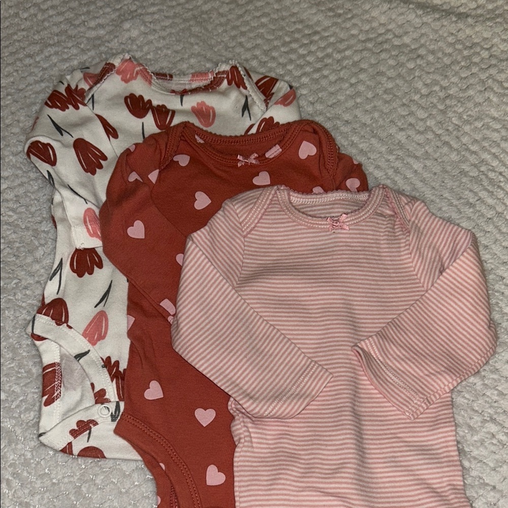 Set of Three Baby Onesies with Floral and Heart Patterns
